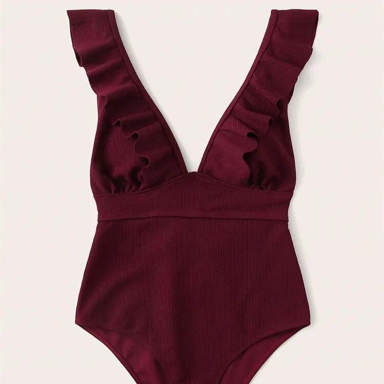 Jednoczęściowy strój kąpielowy z głębokim dekoltem